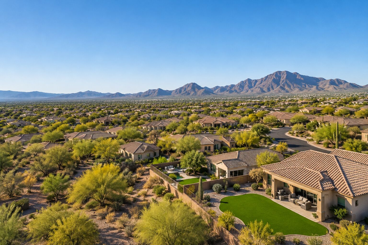 Aerial view of a desert neighborhood with artificial turf backyards